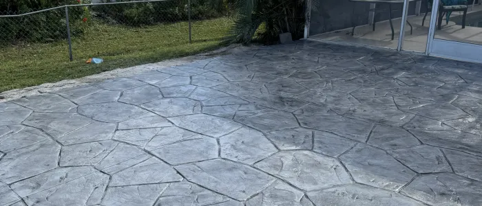 Grey stamped concrete patio with natural stone texture